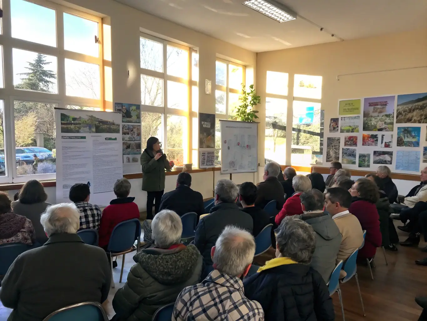 A photograph of a group of people attending a historical lecture or workshop, engaged in learning about local heritage and preservation techniques, in a well-lit and inviting setting.